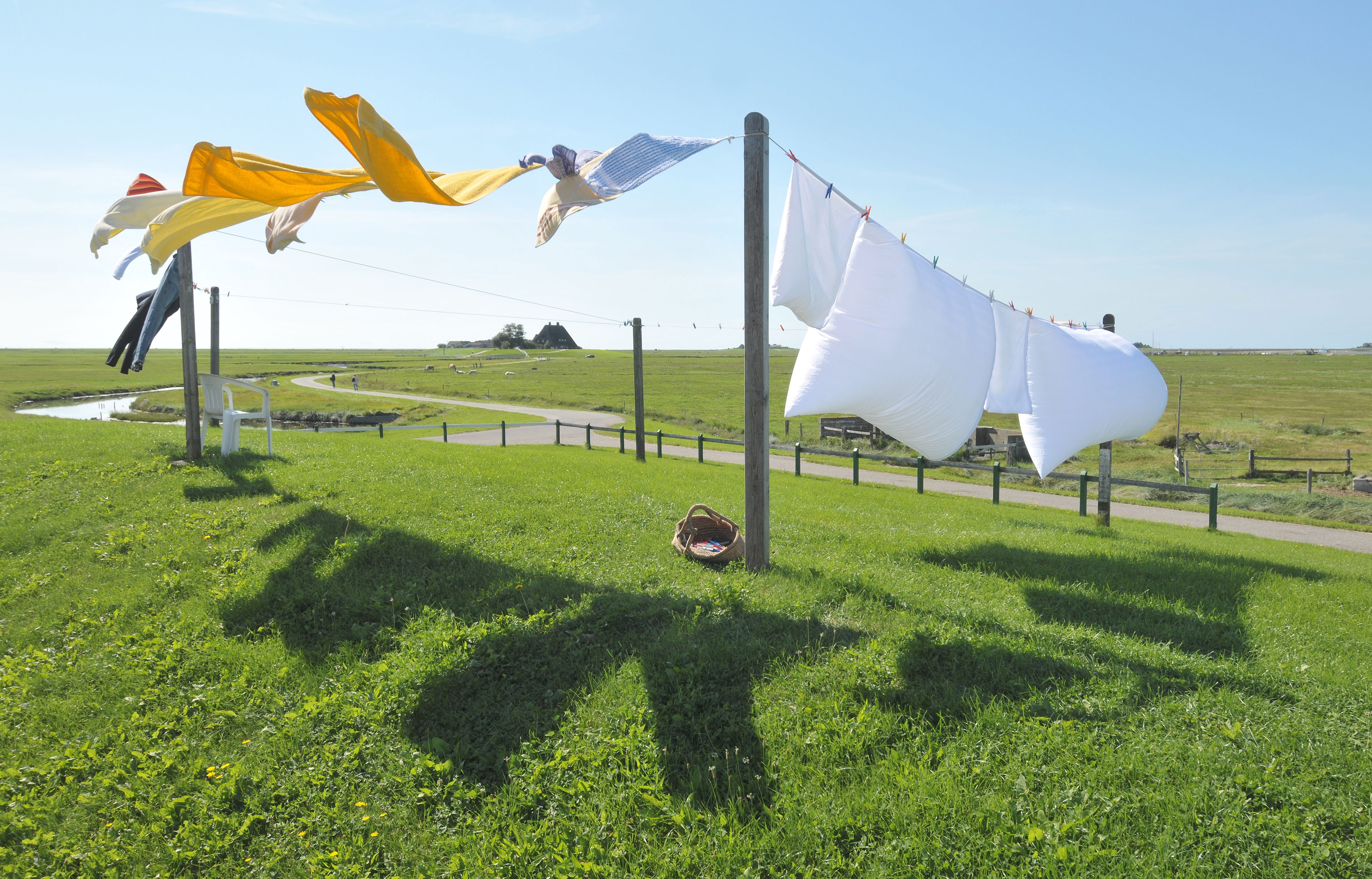 The image shows clothes drying on a clothesline on a bright sunny day.