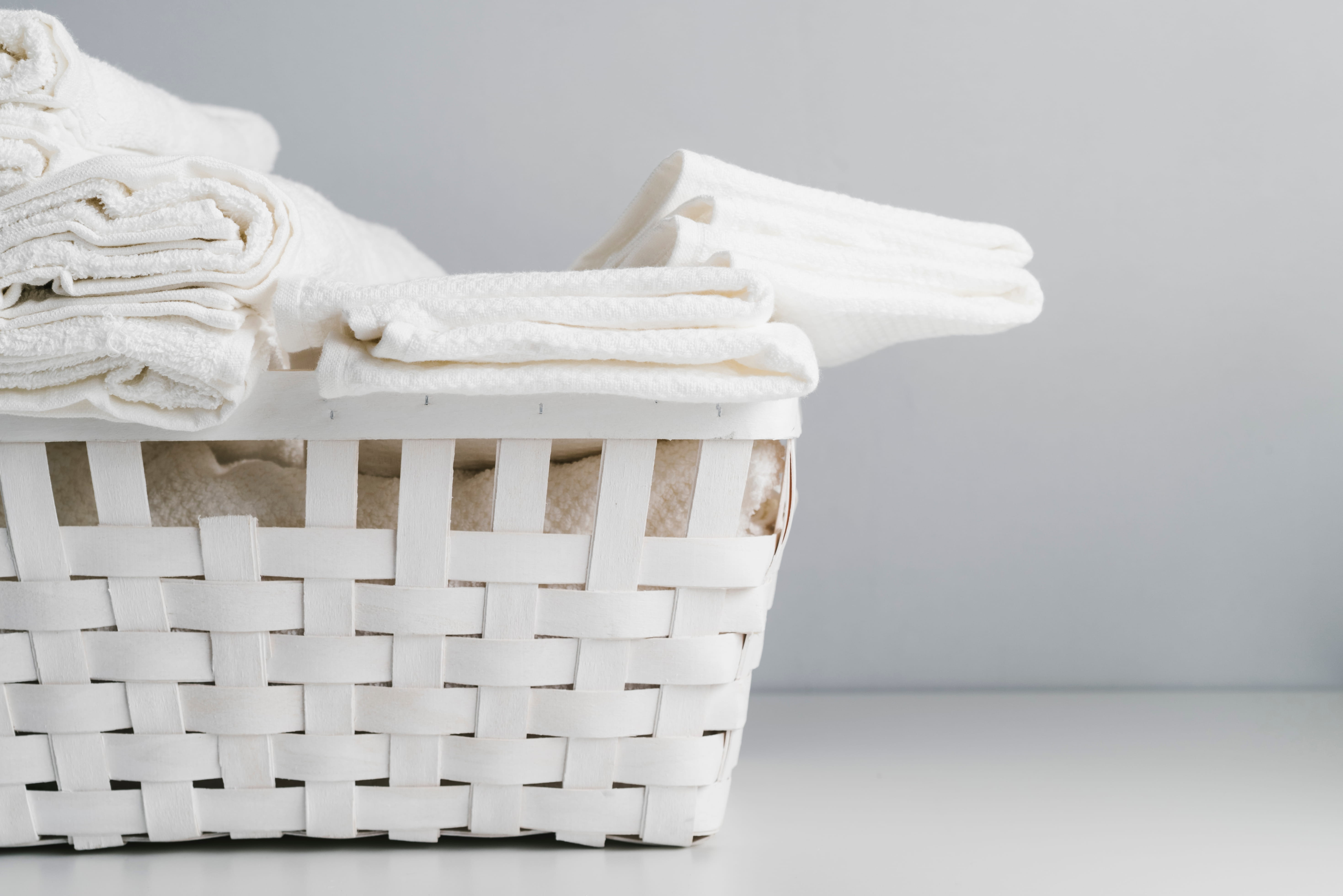 white basket with towels